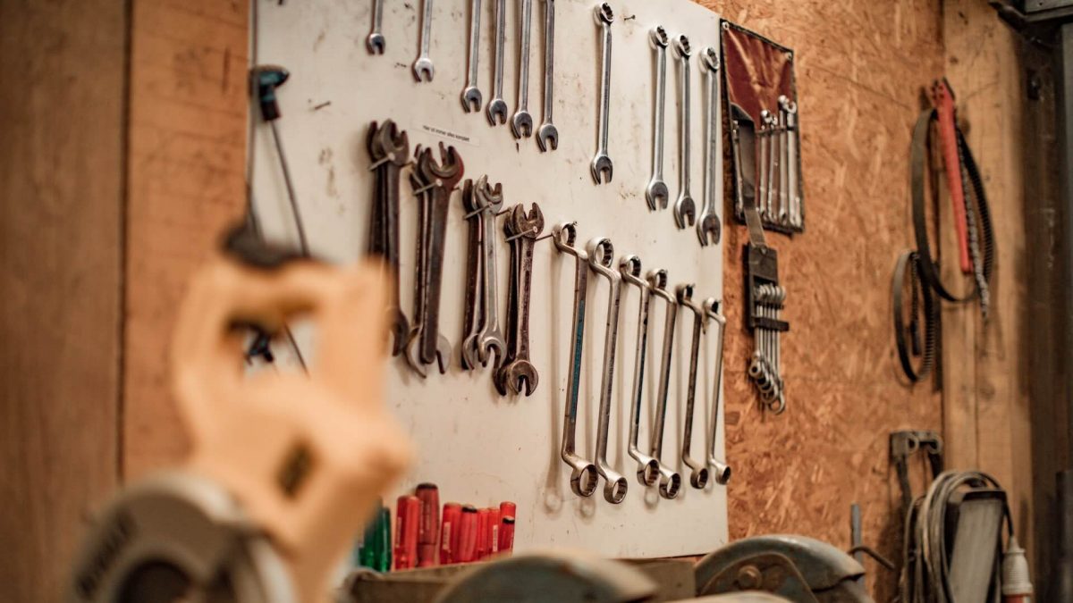 A well-arranged garage space displaying an array of neatly lined-up tools.